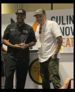 Chef Ken accepting 1st Place at the Florida Restaurant & Lodging Show Rapid Fire Competition 2023